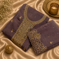 Purple fabric with gold embroidery on a beige fabric background